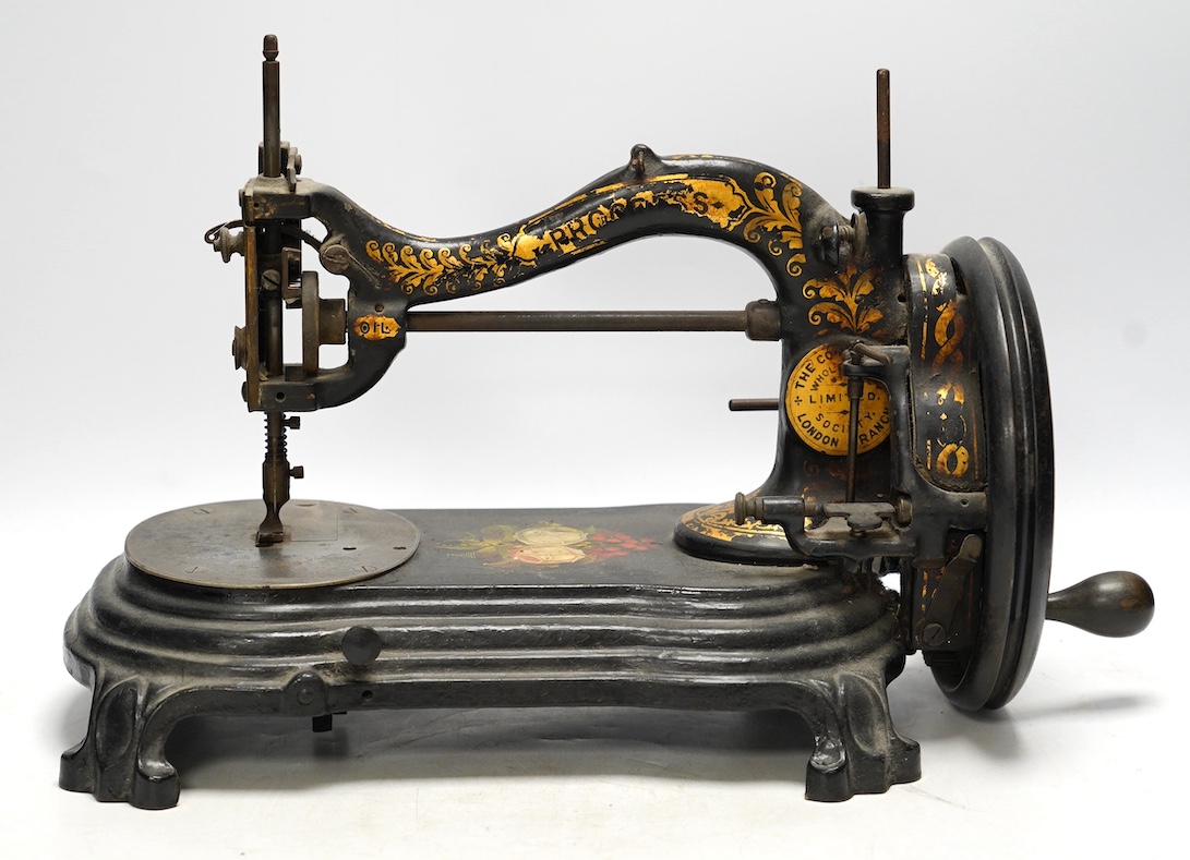 A late 19th century Bradbury & Co Wellington sewing machine on a cast iron base with gilt and floral decoration. Condition - fair